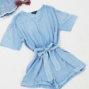 Light denim play suit worn for waist and hidden button down front